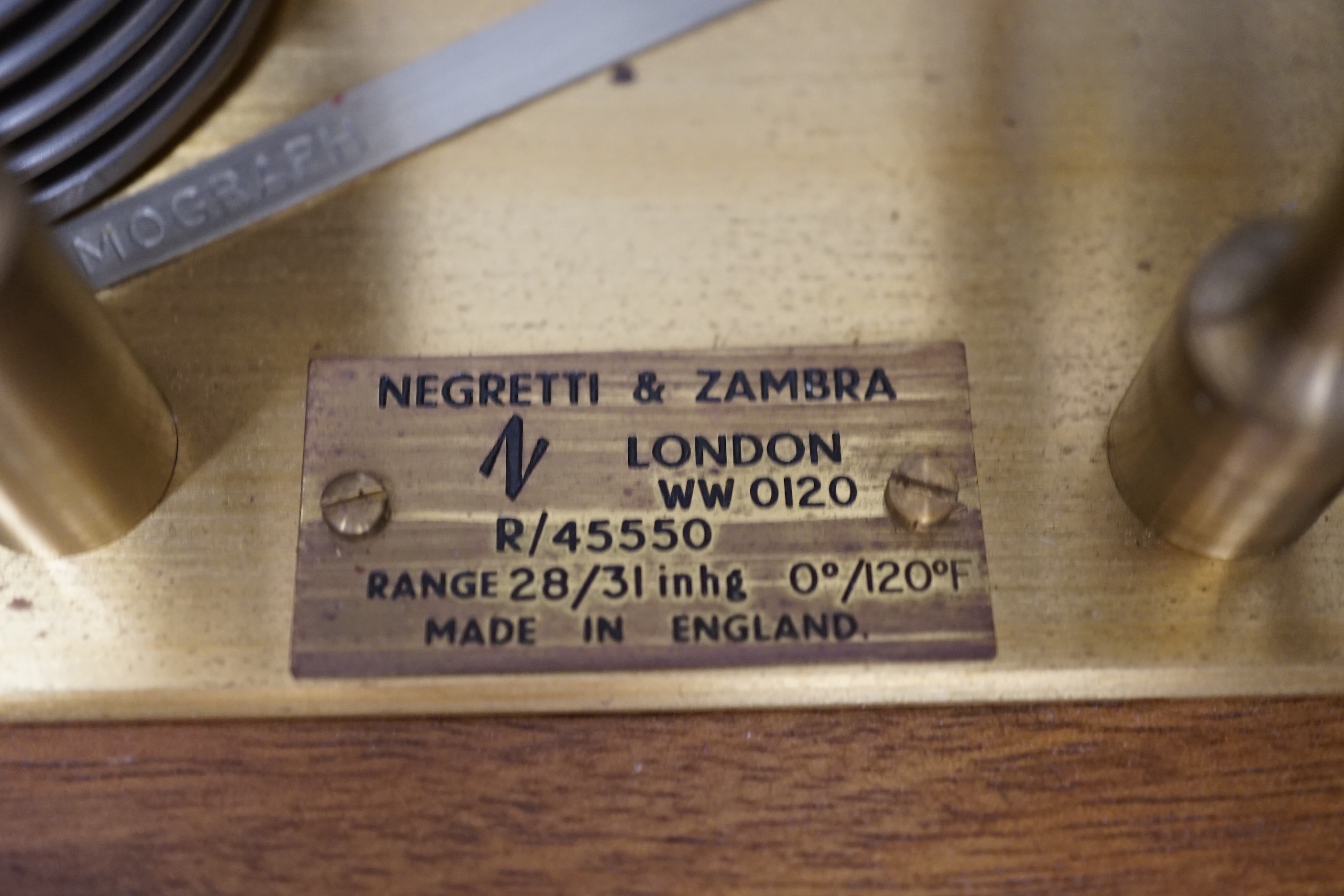 A Negretti & Zambra teak barograph with spare graph paper in case draw. 36cm wide.